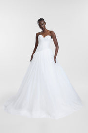 A model wearing the Pippi Gown, an ivory tulle ballgown with a strapless sweetheart neckline, fitted bodice and full layered skirt.